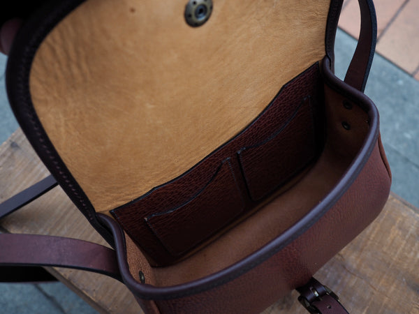 Inside of purse has 2 card holder pockets attached to larger pocket.