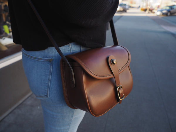 Medium brown leather purse with flap.  Solid brass quick snap and rounded buckle.