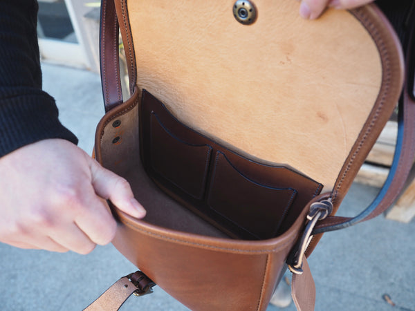 Inside of purse has 2 card holder pockets attached to larger pocket.